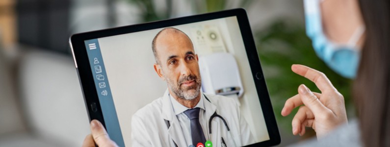 Woman having a Telehealth conference with her doctor using her tablet.