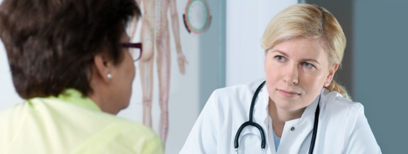 Medical doctor discussing insurance costs with a patient.