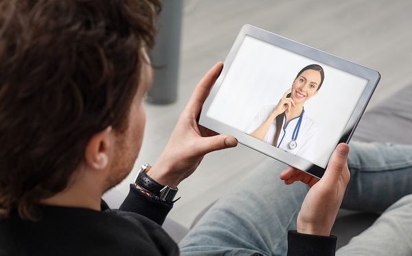 man with iPad talking to doctor