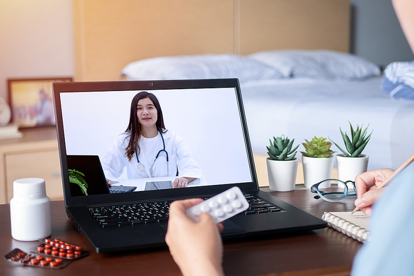 person on telemedicine call with doctor reviewing medication