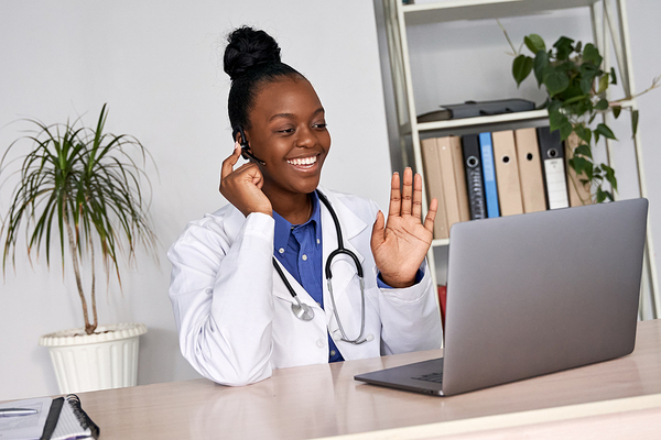 doctor smiling while on computer telemedicine call