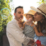 family blowing bubbles