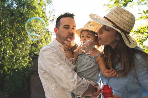family blowing bubbles