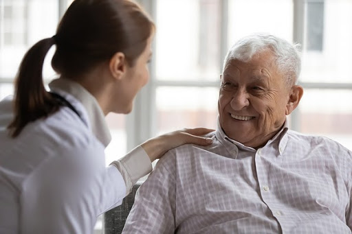 woman doctor hand on shoulder of patient