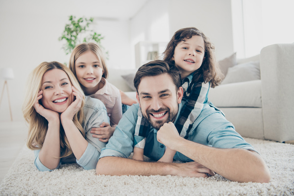 family lying on floor and smiling
