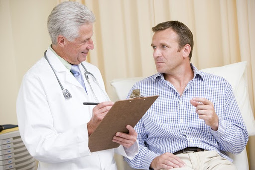 man and doctor in exam room