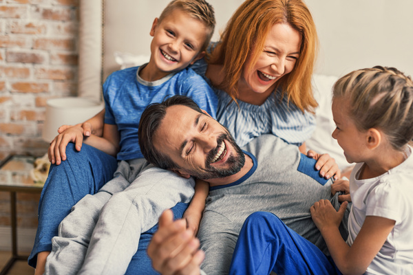 family laughing and piled up on each other